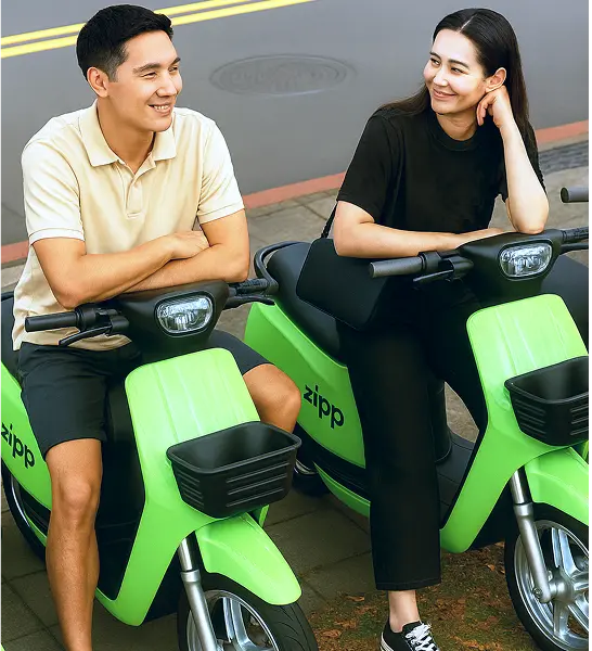 Customer exploring a Zipp scooter with a teammate